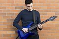 Adam Darksworn with his guitar.jpg